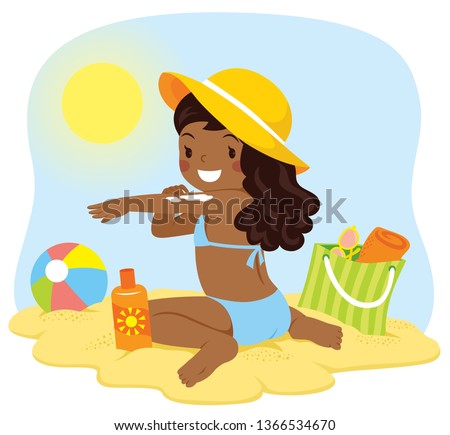 Cute dark skinned girl applying sunscreen at the beach