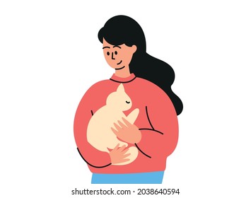 A cute dark  haired girl is holding cat in her arms  A domestic cat  pet is sitting his hands  A woman and cat
