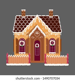 Cute decorative gingerbread house with patterns and candles.

