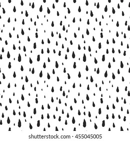 Cute decorative seamless pattern with raindrops. Hand drawn ink different sizes black drops with rough edges on white background. Endless backdrop for childish decoration, cloth or wrapping