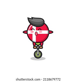 The cute denmark flag badge character is riding a circus bike , cute style design for t shirt, sticker, logo element