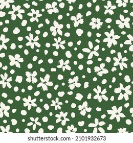 Cute ditsy daisies with dots all over print on green background. Random placed, vector flowers and stains seamless repeat pattern. Minimal print for apparel, surfaced, backgrounds etc.