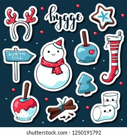 Cute doodle hygge stickers. Vector hand drawn stickers with hygge lettering and cozy things: snowman, deer antlers, marshmallows, apple in caramel, stocking, north pole sign, cinnamon, christmas tree.