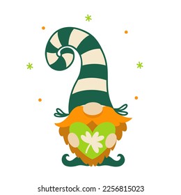 A cute dwarf holds a green heart with shamrock in his hands. Red-bearded elf for good luck. Irish gnome in a striped stocking cap. Funny leprechaun, symbol of St. Patrick's Day. Isolated on white