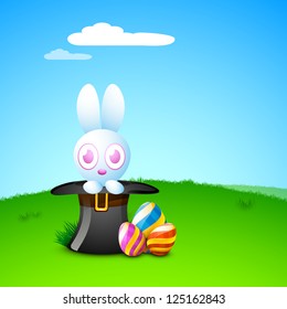 Cute Easter Bunny with beautiful painted Easter Eggs on grass, nature background. EPS 10.