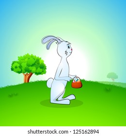 Cute Easter Bunny holding Easter Eggs basket on nature background. EPS 10.