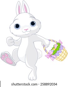 A cute Easter bunny holds full basket of colored egg