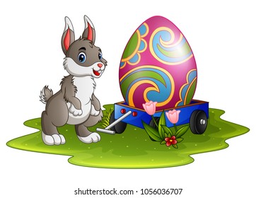 Cute easter bunny with large eggs painted on a cart