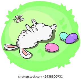 Cute Easter bunny is lying on his back and watching a flying butterfly