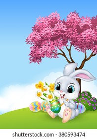 Cute Easter Bunny painting an egg