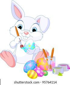 Cute Easter Bunny painting an egg