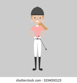 Cute equestrian horse rider girl smiling and standing isolated on gray background in white breeches and pink polo with whip