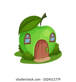 Cute fantasy house in form of ripe apple surrounded by green bushes. Cartoon home with wooden arched door and windows. Colorful flat vector design