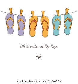 Cute flip-flops hanging on clothesline for summertime design