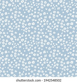 Cute floral pattern. Seamless vector pattern. Elegant template for fashion prints. Small white  flowers for print.  Cyan blue background. Stock vector.