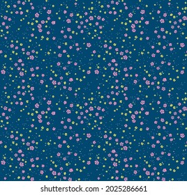 Cute floral pattern. Seamless vector pattern. Elegant template for fashion prints. Small pink and yellow flowers for print. Blue background. Stock vector.