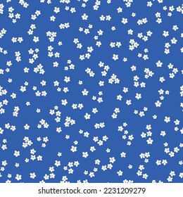 Cute floral pattern. Seamless vector texture. An elegant template for fashionable prints. Print with small white flowers. blue background.