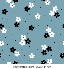 Cute floral pattern. Seamless vector texture. An elegant template for fashionable prints. Print with white and black  flowers and dots. blue background.