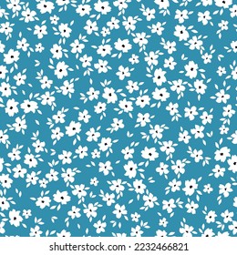 Cute floral pattern. Seamless vector texture. An elegant template for fashionable prints. Print with small white flowers and  leaves. blue background.