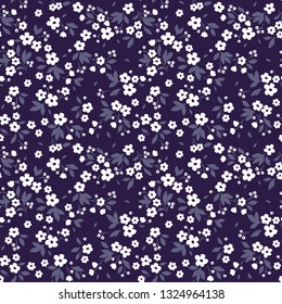 Cute floral pattern in the small flower. Ditsy print. Seamless vector texture. Elegant template for fashion prints. Printing with small white flowers. Dark blue background.