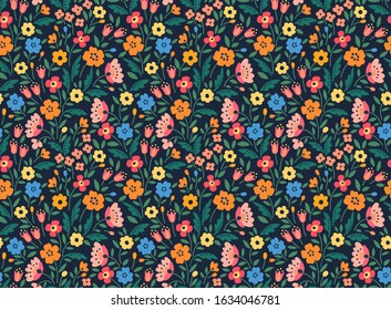 Cute floral pattern in the small flower. Print in folklore style. Seamless vector texture. Elegant template for fashion prints. Printing with small colorful flowers.  Dark blue background.