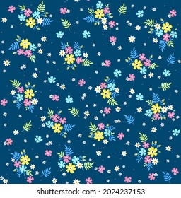 Cute floral pattern in the small flower. Seamless vector texture. Elegant template for fashion prints. Printing with small colorful neon flowers. Blue background. Stock vector for prints on surface.