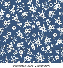 Cute floral pattern in a small flower. Seamless vector texture. An elegant template for fashionable prints. Print with small white and blue flowers. Blue background. Stock print.