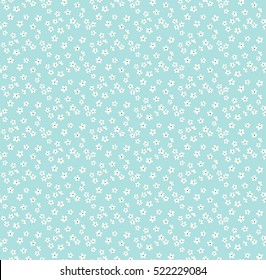 Cute Floral pattern in the small flower. "Ditsy print". Motifs scattered random. Seamless vector texture. Elegant template for fashion prints. Printing with very small white flowers. Blue background.