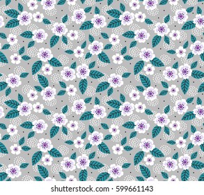 Cute floral pattern in the small flower. Ditsy print. Motifs scattered random. Seamless vector texture. Elegant template for fashion prints. Printing with small white flowers. Gray background