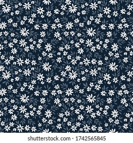 Cute floral pattern in the small flowers. Ditsy print. Motifs scattered random. Seamless vector texture. Elegant template for fashion prints.  Dark blue background.