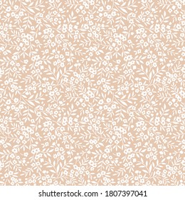 Cute floral pattern in the small flowers. Seamless vector texture. Elegant template for fashion prints. Printing with small white flowers. Light beige background.