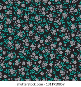 
Patrón floral lindo en flores pequeñas. Textura vectorial sin inconvenientes. Elegante plantilla para impresiones de moda. Flores grises, fondo oscuro.