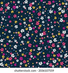 Cute floral pattern in the small flowers. Seamless vector texture. Elegant template for fashion prints. Printing with small pink, white and yellow flowers. Dark blue background.