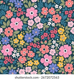 Cute floral pattern in small flowers. Small pink, yellow, orange, and white flowers. Dark blue background. Ditsy print. Floral seamless background. Liberty template for fashion prints. Stock pattern.