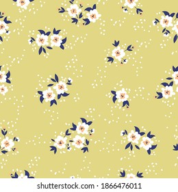 Cute floral pattern in white flowers. Seamless vector texture. Elegant template for fashionable prints. Spring bouquet. Pale mustard background.