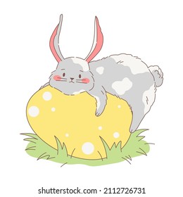Cute fluffy bunny lies and hugs a big Easter egg. Vector illustration of a chubby hand drawn grey and white rabbit. Cartoon sweet style design.
