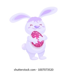 Cute fluffy pink bunny with painted egg, Easter decoration element, cartoon vector illustration isolated on white background. Smiling cartoon Easter bunny, rabbit, hare holding decorated egg