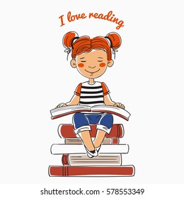 Cute, funny girl reads a book sitting on a stack of books