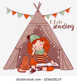 Cute, funny girl sitting inside a tepee tent and reading a book. Little girl with a cat