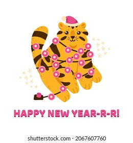Cute and funny new year tiger in Santa hat sits with Christmas lights garland