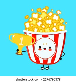 Cute funny popcorn hold gold trophy cup. Vector hand drawn cartoon kawaii character illustration icon. Isolated on blue background. Popcorn with winner trophy cup