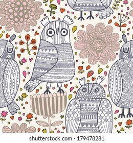 Cute funny seamless pattern with cartoon owls in flowers. Seamless pattern can be used for wallpaper, pattern fills, web page background, surface textures.