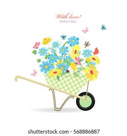 cute garden wheelbarrow with wild flowers with love. mother's day