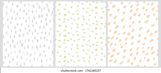 Cute Geometric Seamless Vector Patterns. Pastel Green, Yellow and Light Gray Free Hand Spatters Isolated on a White Background. Simple Abstract Vector Prints. Watercolor Style Brush Spots. Scribbles B