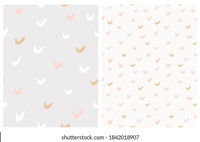 Cute Geometric Seamless Vector Patterns with Brush Daubs Isolated on a Light Gray and Off-White Background. Funny Infantile Hand Drawn Doodle Print with Simple Gray, Pink and Gold Irregular Spots.