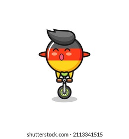 The cute germany flag badge character is riding a circus bike , cute style design for t shirt, sticker, logo element