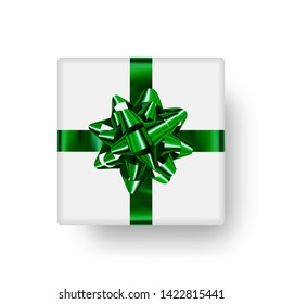 Cute gift box with shiny green bow in the shape star and realistic shadow. Top view. Ready clipart object to decorate holiday banner, poster, card and more.