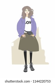 Cute girl in a blue jacket, a brown skirt and a t-shirt with a print