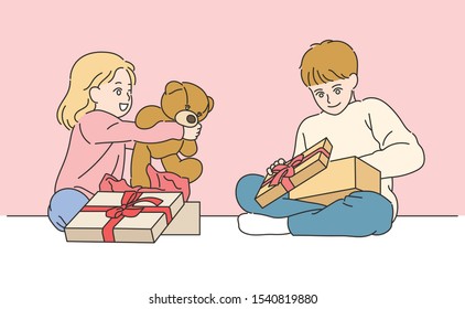 Cute girl and boy are sitting on the floor and opening a gift box. hand drawn style vector design illustrations. 