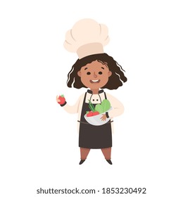Cute Girl Chef Cook Holding Bowl with Fresh Vegetables, Kid in Chef Uniform Cooking in Kitchen Cartoon Style Vector Illustration